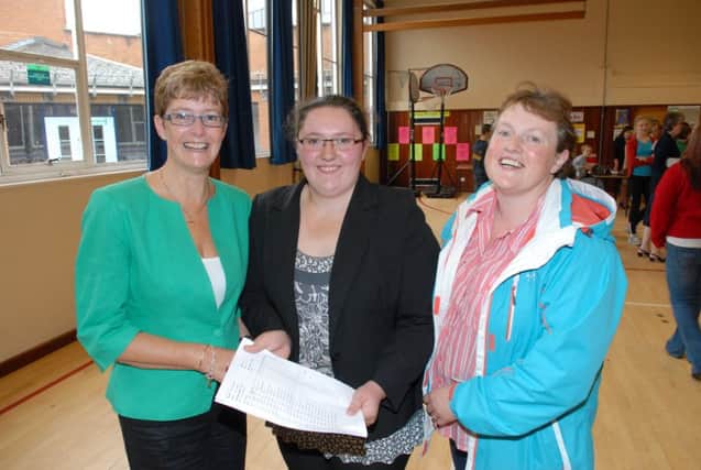 Laura Currie received excellent results of 4A*s and 5As in her GCSE exams at Ballyclare Secondary School. Congratulating her are mum Jennifer (right) and principal Mrs Bell. INNT 35-346-PR