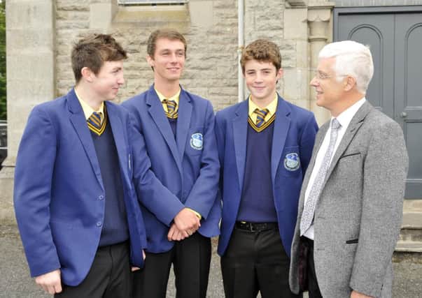 Adam Kelly, Ronan Kearney and Anton McConville who were sucessful in the GCSE examinations chat with St Michael's Grammar School principal Mr Gerard Adams. INLM35-110gc