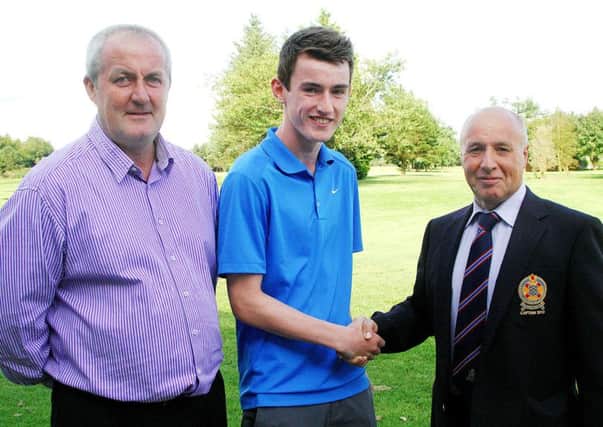 Ballymena Golf Club Junior Captain's Day winner Andrew Adams is congratulated by Club Captain Jim Drennan watched by David Small. INBT 35-813H