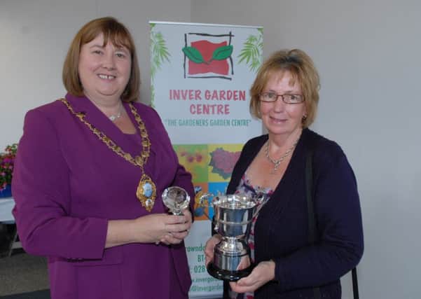 Larne Mayor Maureen Morrow presents Rita O'Lynn with one of her trophies at the Larne Borough Council Flower Show. INLT 35-357-PR