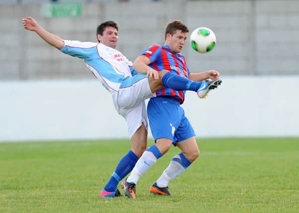 Ballymena United's Mark McCullagh tussles with Ards' Neil Dougan at Dixon Park.
