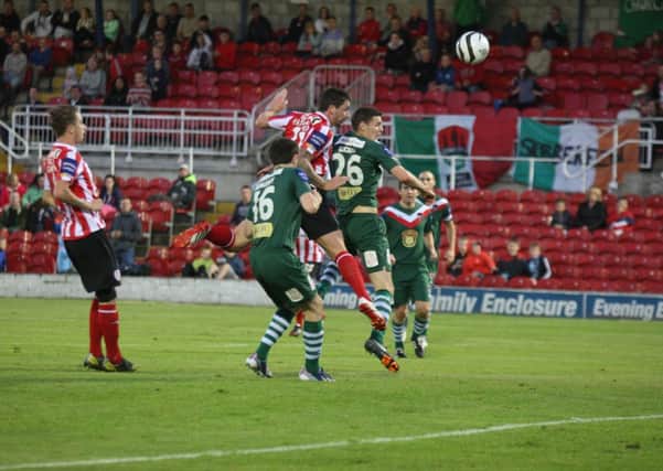 Rory Patterson out-jumps Garry Buckley to get this header in during Friday night's match at Turner's Cross.