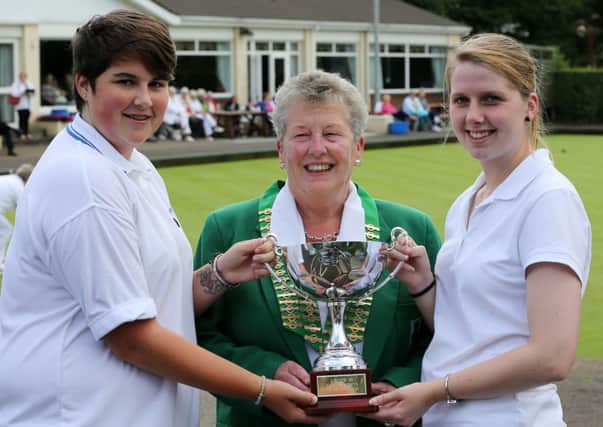 Megan Wilson (right) of Ballymena Bowling Club and her partner Chloe Watson of Comber Bowling Club receive the Irish Under 25 Ladies Pairs trophy from President Dorothy McKee after they beat Claire McCaw and Rachael McDonald from Ballymoney Bowling Club in Friday's final at the IWBA finals at Ballymena Bowling Club. INBT 36-181CS