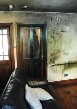 The Moat Road house living room with fire damage to the wall, floor and ceiling from the petrol bomb attack on Friday evening. The two children in the house were sitting on the sofa when the attack happened. INBT 36-857H