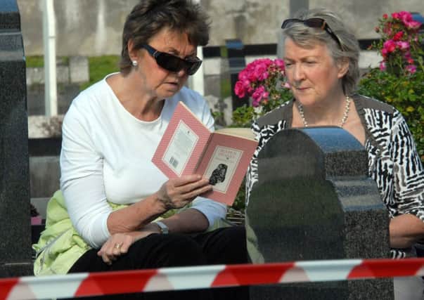 Sitting in the September sunshine they ponder on 'Wintering Out' by Seamus Heaney as they await the arrival of his funeral cortège to Bellaghy graveyard. INMM3614-209ar.