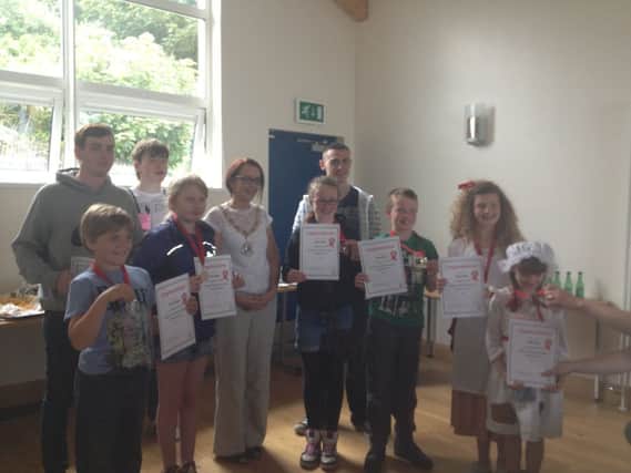 Chair of Moyle District Council, Cllr Cara McShane, presents prizewinners with their awards in the Street Entertainers competition. INBM37-13