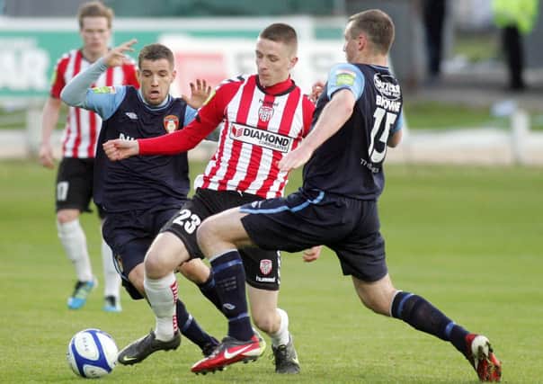 Derry City's Ryan Curran attempts to keep the ball away from St. Patrick's Athletic duo Darren Meenan and Kenny Browne (NO 15).