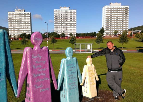 Urban poet: Hip hop artist Johnny Hamilton aka Jun Tzu pictured in the Rathcoole estate, where he lived before moving to Manchester.