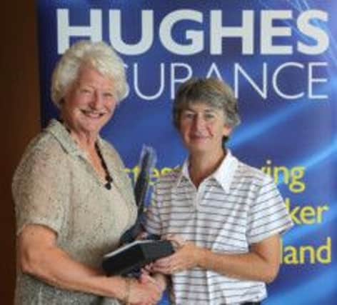 Galgorm Castle golfer Beth Moore receives the Mary Peters Trust prize from the former Olympian.