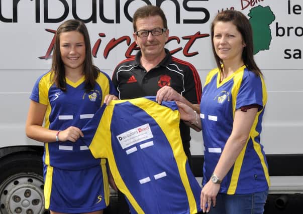Finbar Headley, owner of Distributions Direct presents a new playing kit for New City Junior Netball Club to Cieara Furphy and Joanne Heasley, coach. INLM35-100gc