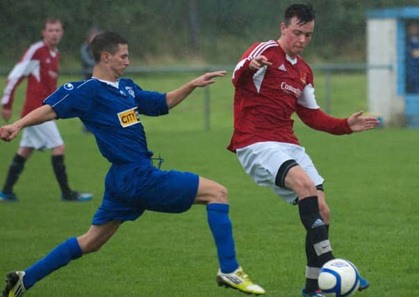 Ryan Curry, Foyle Wanderers, and Sean Hargan, Churchill United, tussle for the ball at Wilton Park on Saturday. INLS3713-224KM
