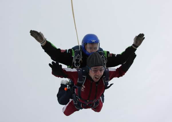 A photograph of Paul Kayne and his dive buddy Stevie Kerr, in mid fall as he sky dives for The Meningitis Trust.