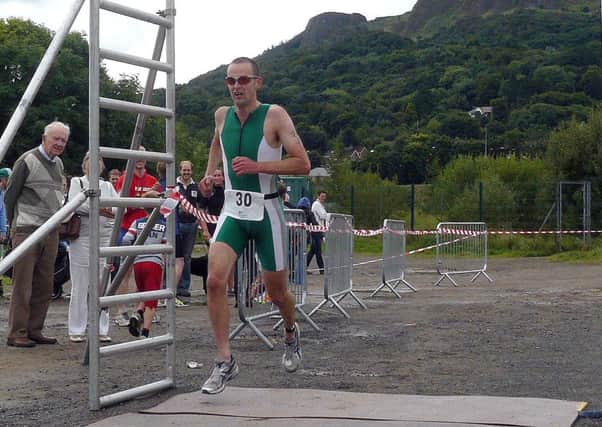 Brian Campbell crosses the finish line at the Stena Line triathlon in Newtownabbey on Sunday. INNT 37-105-CON