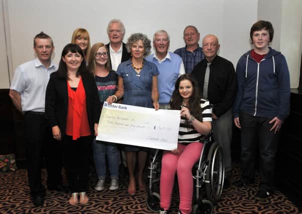 Caitriona Hughes receives £340 for Cancer Research UK from members of Cantabile Choir. INLM37-108gc