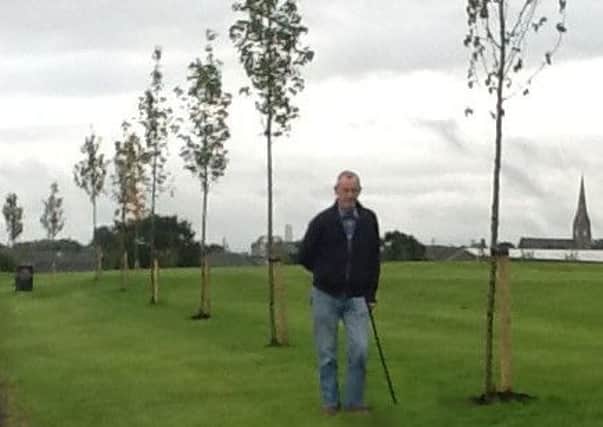 Cllr McGeown beside some of the new trees in Lord Lurgan Memorial Park