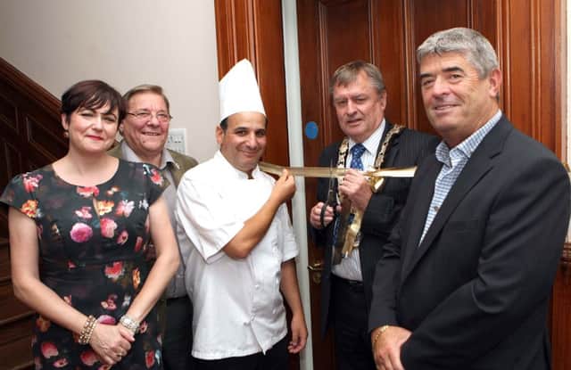 Mayor Fraser Agnew cuts the ribbon to open the new La Table Tearoom in Merville House with owner Abel Mehablia and Lisa Barr (Business Development Manager Merville House Ltd), Billy Snoddy (Chairman) and Councillor Billy Webb (Director). INNT 36-030-FP