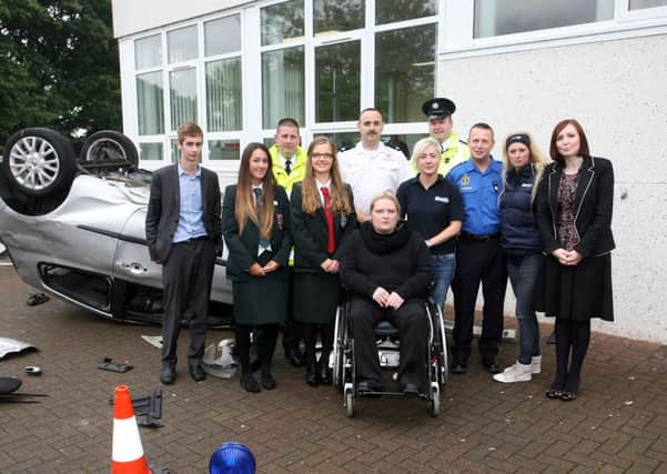 Students from Cambridge House, pictured along with representatives from the PSNI, Fire Service, Ambulance Service, Cool FM and AXA insurance at a road safety event held in Cambridge House. INBT38-201AC