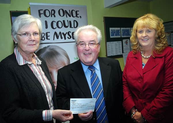 Former Ballymena Mayor Alderman PJ McAvoy presents a £1400 cheque to Margaret Black, Ballymena Samaritans; proceeds of his charity fund while in office. Looking on was Rea Kirk, fund raising manager. INBT 38-804H