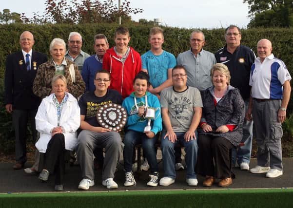 Members of Old Bleach, winners of the Connie Scott Memorial Cup, are pictured receiving the trophy from Tammy Scott, granddaughter of the late Connie Scott. The club are also pictured with the Evans Shield after their mid week triples league success. Included is George Barnes, President of Old Bleach Bowling Club. INBT38-239AC