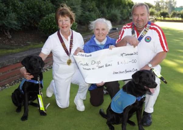 Mirdza Oak (centre) from Guide Dogs for the Blind receives a cheque from Lagan Valley Bowling Club Madam President Rosemary O'Carroll and President John Houston during President's Day at the club. US1338-541cd