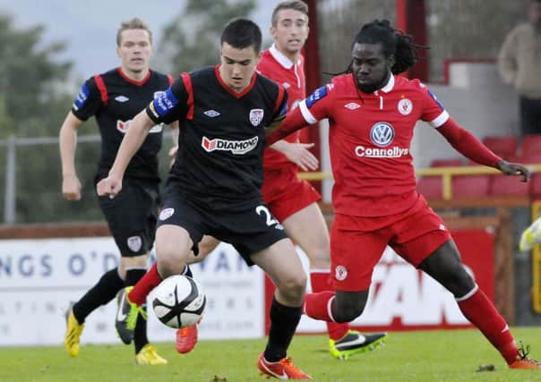 Derry City's Michael Duffy holds off Sligo Rovers winger Pascal Millien, during Sunday's FAI Ford Cup quarter-final tie, at the Showgrounds.