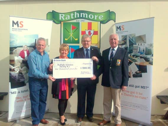 Kenny and Marian McDowell present a cheque to Tom Mallon (MS Society NI) ably supported by Rathmore Club Captain Rodney Montgomery.