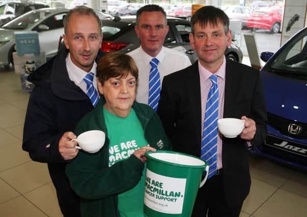 Margaret Jamieson, of Macmillan Cancer Support, helps to promote the Macmillan World Largest Coffee Morning with Nigel Cole, Jonny Weir and Brian Harding of Donnelly and Taggart Honda. The coffee morning is on September 27 from 9am - 1pm at the local car showroom. INBT38-241AC