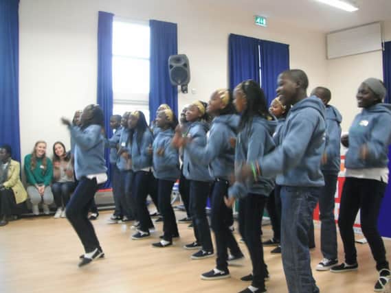 The Ugandans perform for the Garryduff pupils and staff. INBM39-13