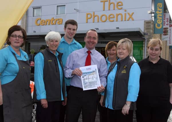 Peter McCool with some of his staff from The Pheonix who raised a total of £1800 for Action Cancer by completing the Giants Walk at the Giants Causeway. A total of 21 staff from the shop took part in the challenge. INBT38-240AC