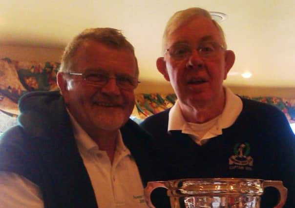 George Gillespie, Captain of Dunmurry, right, presents the Bradbury Cup to Peter Cairns, Vice Captain of Lisburn.