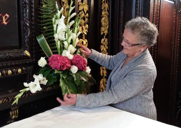 Mu member arranging flowers each week in the church.