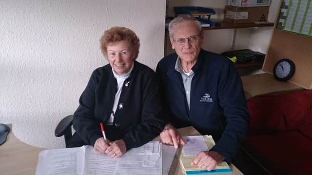Barbara Miers (nee Agnew) and her husband Bruce Miers pouring over their genealogical research.  INLT 39-680-CON