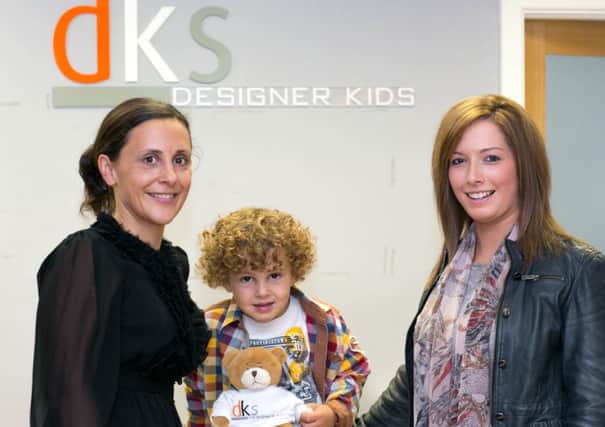 Blake pictured with mum Julie Hunter and Rebecca Warwick from the store in Ballyclare. INNT 38-428-RM