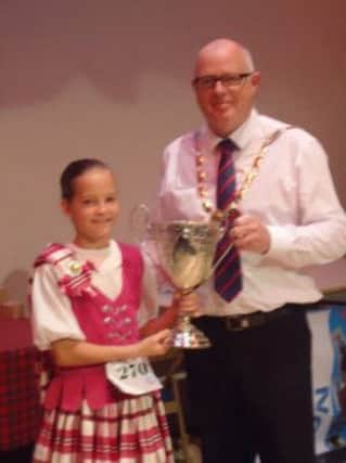 Katy Barham, Clan Davidson Dancer with the most points in the competition, pictured with Cllr Drew Niblock.  INLT 39-686-CON