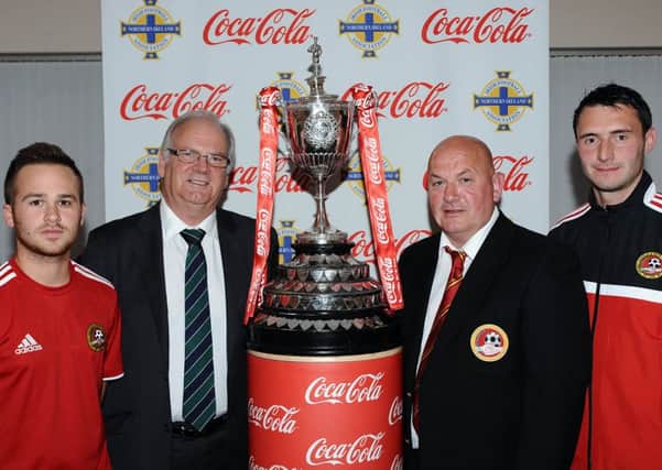 Carniny Amateurs Players Matthew O'Flaherty, Mervyn Martin (IFA Intermediate Chairman) manager Anthony McCartney and David Hanna at the draw of the Intermediate Cup last week. The Ballymena club will play Sirocco Works FC.