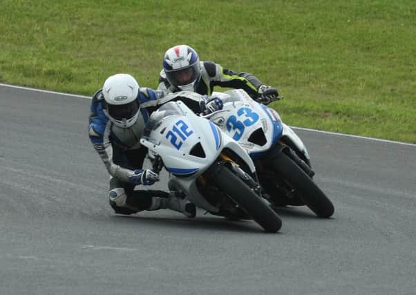 Dean McMaster, from Cullybackey, dives under Mark Hanna in the Supersport 600 race at Bishopscourt. Picture: Roy Adams.