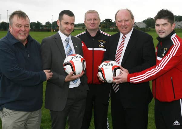 Cllr. Timothy Gaston and Jim Allister MLA present sponsored footballs to David Armstrong, Robert Duddy (manager) and Bam Craig of Harryville Homers. INBT39-230AC