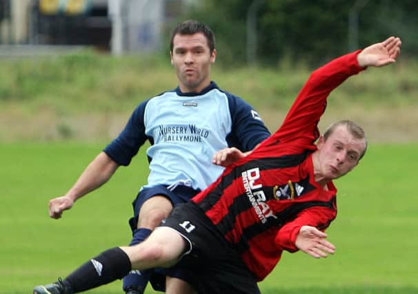 A Harryville Homer player gets caught off balance by his Ballybogey opponent. INBT39-232AC