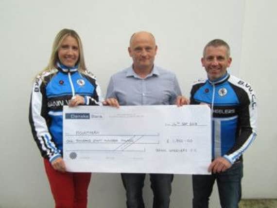 Bann Wheelers present Michael Bacon with a cheque on behalf of Mountfern Adult Centre.
