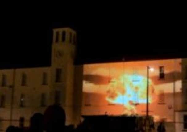 A nuclear explosion projected onto the former military barracks at Ebrington during the world premiere of Haris Pasovic's 'The Conquest of Happiness' at the weekend.