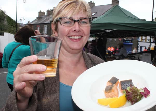 Sharon MC Killop, (organisor) has a dram  of Whiskey and  taste of Salmon at a Salmon and Whiskey  Festival in Bushmills over the weekend.INBM39-13 601F.