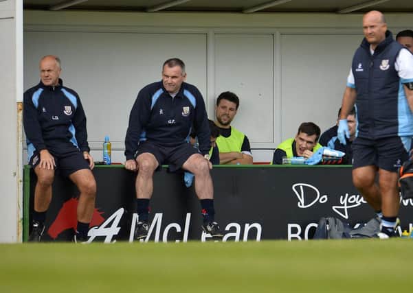 Glenn Ferguson, his coaching staff and substitutes watch from the dugout during Saturday's game at the Oval. Picture: Press Eye.