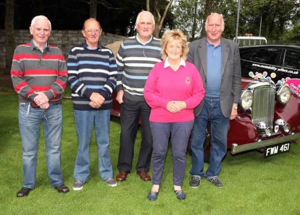 Ethna Tosh (event organiser) pictured with Graham Lowe, Ian Logan, Dessie Wright and Will Browne of the Coleraine and District Historic Vehicle Club who supported the tournament in aid of Coleraine Samaritans at Brown Trout Golf Club.
