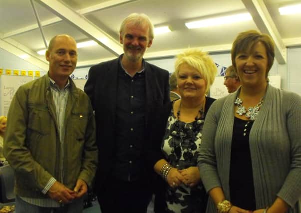 Tim McGarry with Ballycarry Community Association members Eddie Belch, Lisa Haslett and Carla McKeaveney.  INLT 39-692-CON