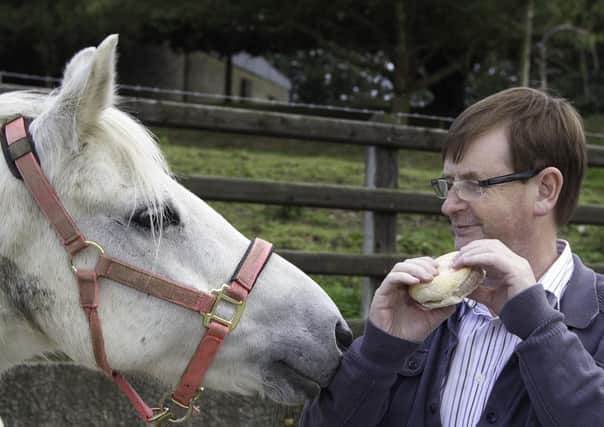 Willie Frazer  with a horse and burger.