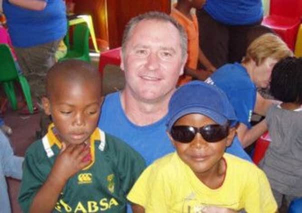 Cllr Declan McAlinden with two kids in Witsand, Western Cape, South Africa where he had been volunteering as part of the Niall Mellon Trust last year
