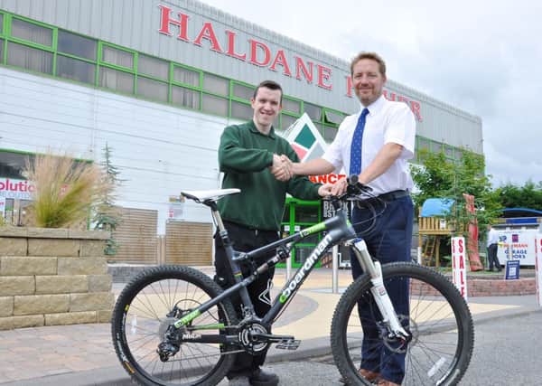 Gareth Hughes, the 50th employee to benefit from Haldane Fishers Cycle to Work scheme pictured with David Haldane, commercial director.INLT 39-667-CON