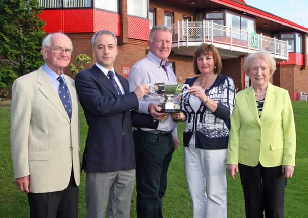 Mr. Michael McCullough, captain, City of Derry Golf Club, presents the Open Mixed Foursomes Matchplay Championship trophy to John and Cheryl Chambers on Sunday afternoon. On right is Mr. Ciaran Burke, and on left, Veronica Burke, tournament organisers. DER3813JM090