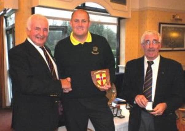 Paul Smyth receiving the Ulster Fourball runners up plaque from Peter Sinclair (Chairman of the Ulster Branch, GUI). Looking on is Patsy McCaffrey (Competition referree).