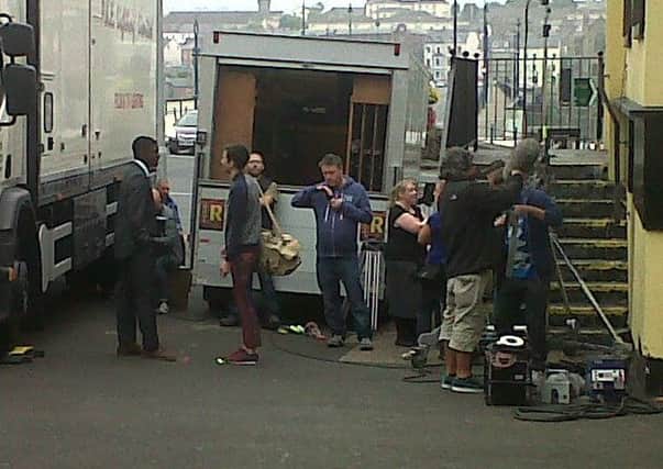 The Hollyoaks film crew and character/actor Vincent Elegba/John Omole, prepare for a take on the courner of Spencer Road and Duke Street this morning, Wednesday.